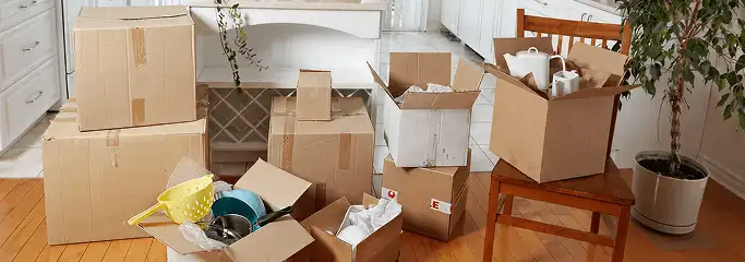 Packed moving boxes and household items in a kitchen before move-out or move-in cleaning, Pembroke Pines, FL.